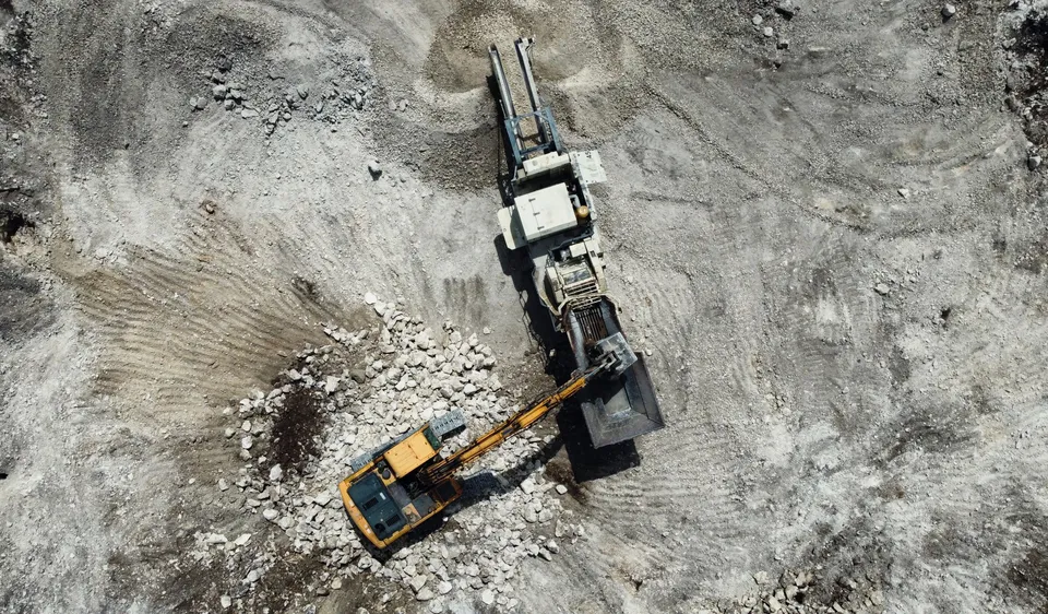 Excavator operating at an open quarry site